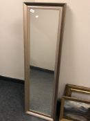 A contemporary mirror in silvered frame,