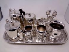 A silver plated serving tray containing four piece tea service, further plated teapot, tankard,