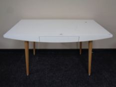 A contemporary two-tone desk fitted a drawer together with a swivel armchair (missing wheel)