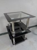 A pair of contemporary glass two tier lamp tables