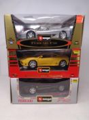 Three Burago 1:18 die cast cars - two Ferrari F50 and a Ferrari 360 Modena,