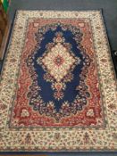 A machine made Persian designed carpet on blue ground