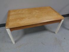 A twentieth century Nathan teak coffee table on painted legs