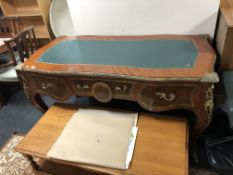 A French bombe desk fitted with three drawer with ormolu mounts and green leather top
