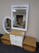 A contemporary two tone bedside chest together with bedside stands and two white framed mirrors