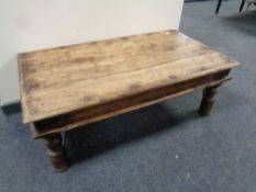 A Sheesham wood coffee table with metal mounts