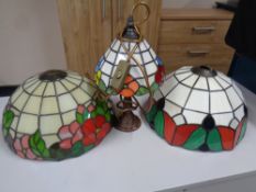 Two leaded glass lamp shades together with further lamp with shade