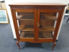 An Edwardian mahogany double door display cabinet on cabriole legs