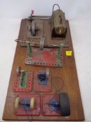 A group of six stationary engines mounted on wooden board