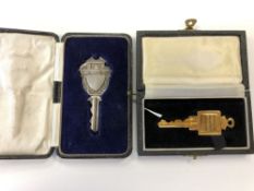 A cased silver key and one other key awarded to the Smith family