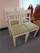 A set of four painted dining chairs