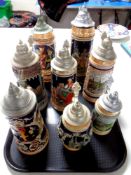 A tray containing eight German beer steins