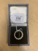 A 15 ct gold circular pearl brooch.