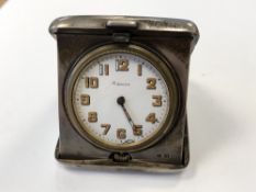 An antique silver cased travel clock