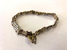 A 9ct gold padlock bracelet CONDITION REPORT: 4.
