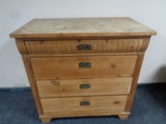 An antique pine four drawer chest