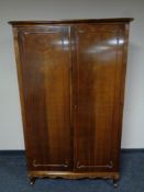 A 20th century walnut double door hanging wardrobe