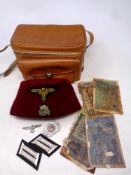 A tray of reproduction German insignia, German bank notes,