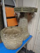 An octagonal concrete garden planter together with a further bird bath