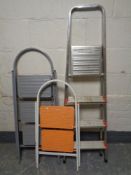 Three sets of folding metal steps