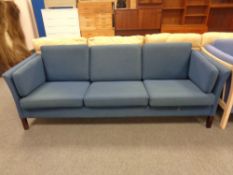 A 20th century Danish three seater settee in blue fabric