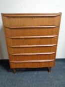A mid century Danish teak six drawer chest on raised legs