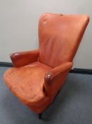 A twentieth century armchair in red leather (a/f)