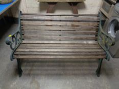 A cast iron wooden slatted garden bench