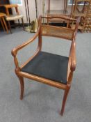 A beechwood bergere backed armchair