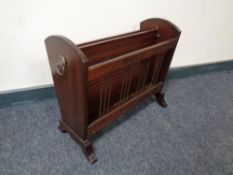 A mahogany magazine rack with lion mask handles