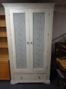 A contemporary double door wardrobe with fabric and wire metal panel doors