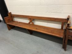 A pitch pine church pew, length 296 cm.