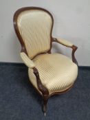 A mahogany framed salon armchair in green striped fabric