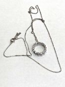 A 9ct white gold circular diamond pendant, approximately 0.46ct.