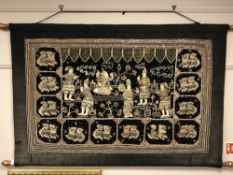 A far eastern embroidery with wire detail depicting figures,