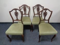 A set of four Edwardian mahogany dining chairs on cabriole legs upholstered in a green dralon