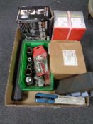 A box containing halogen lights, socket sets, orbital sander,