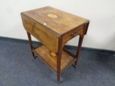 A Victorian inlaid rosewood two tier flap sided serving trolley fitted a drawer