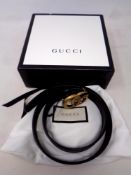 A Gucci black leather belt (waist 34)