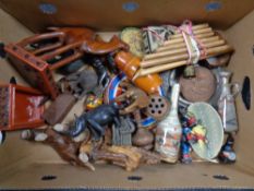A box containing a quantity of assorted tourist carvings, Russian dolls, vintage tins,