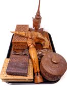A tray of oriental carved wooden boxes and figures