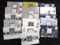 A basket of fifteen Dunelm pillow cases (various,