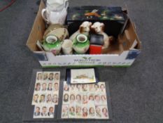 A box including miscellanea to include a pair of spaniels, Players cigarette cards in frames,