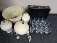 A tray of assorted drinking glasses together with a pair of ceramic table lamps with shades and a