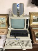 An Amstrad PCW8512 monitor with built in floppy disk drives,