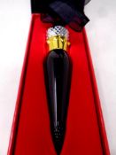 A boxed Christian Louboutin rouge lipstick