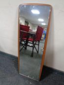 A 20th century frameless mirror mounted on a teak board