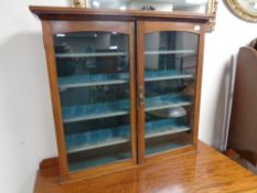 An Edwardian mahogany wall mounted curio cabinet