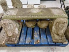 A concrete garden bench with Sphinx supports.