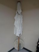 A large garden parasol on a concrete base